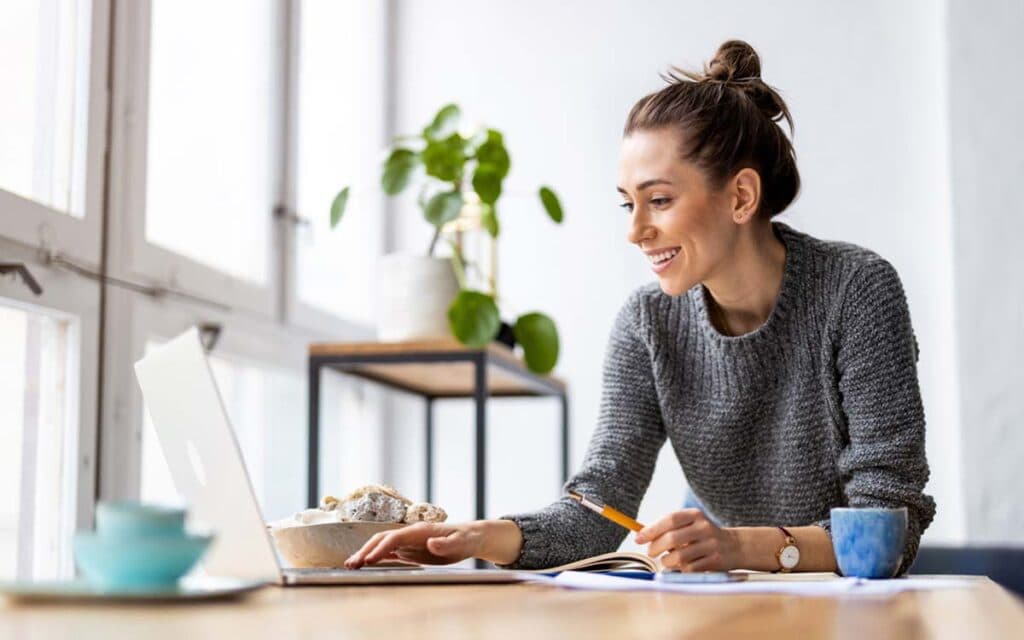 Woman seated at a desk working on a laptop