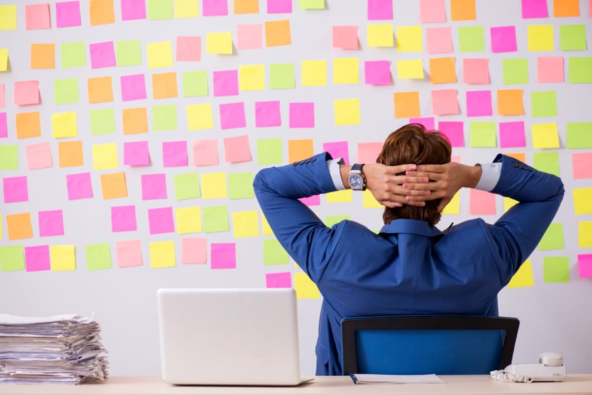 Person sitting looking at board full of sticky notes
