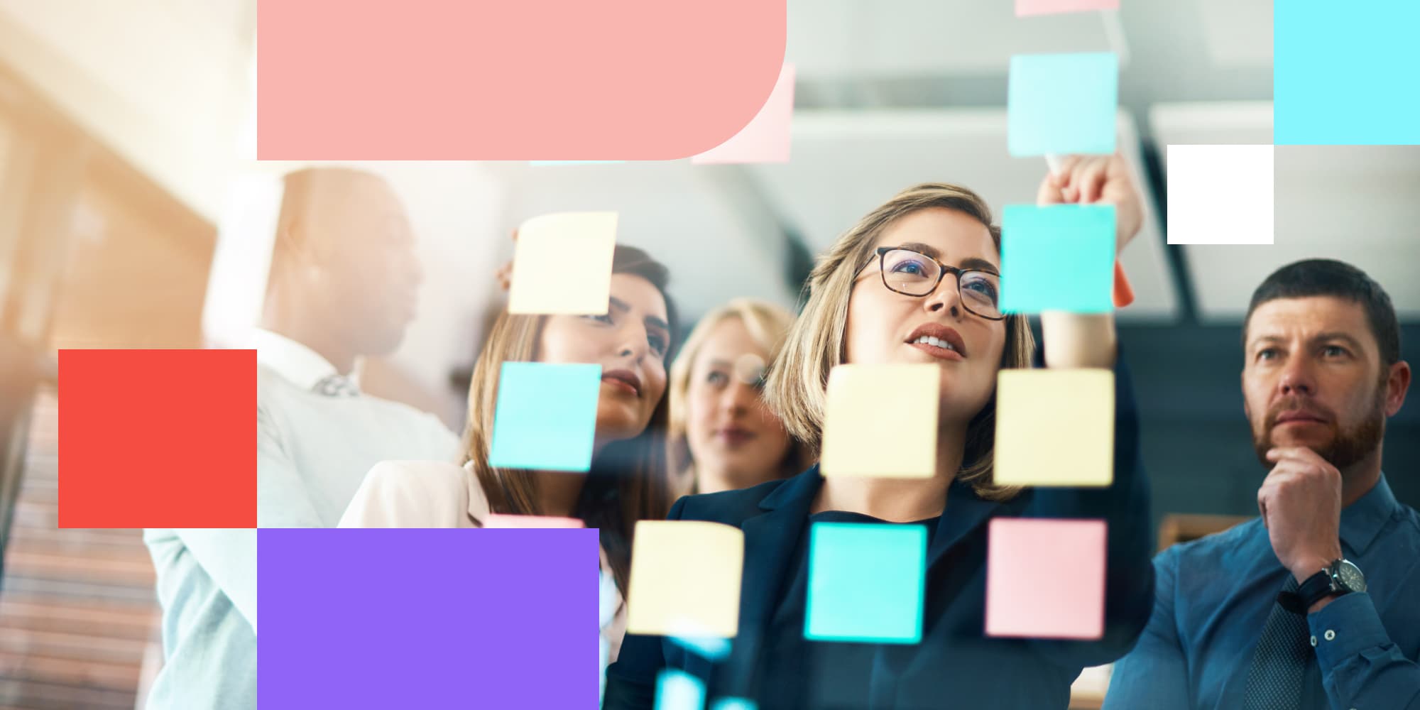 Team working together at board with sticky notes