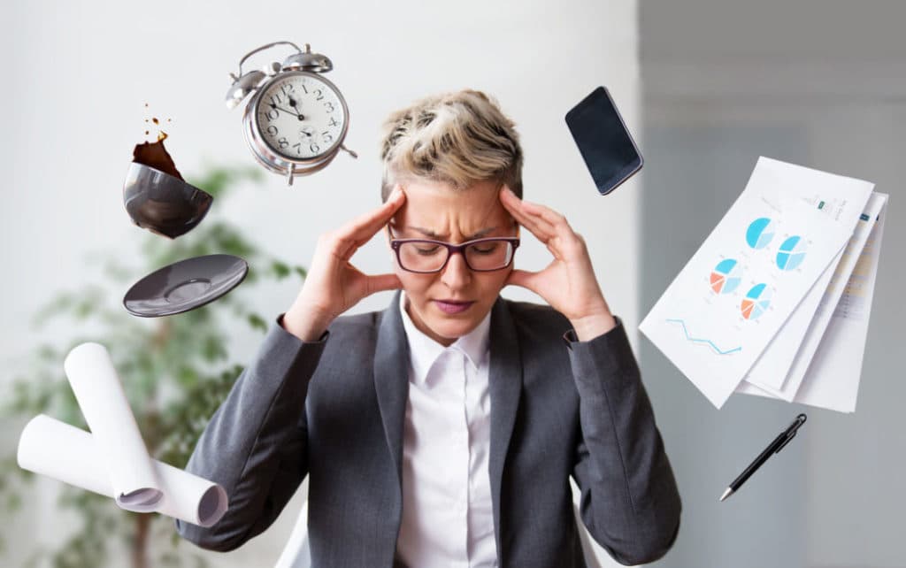 Overwhelmed at work, woman looking stressed