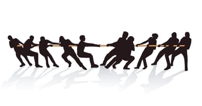 Silhouette illustration of two opposing teams engaged in a tug-of-war, symbolizing competition, teamwork, and the struggle for dominance or success.
