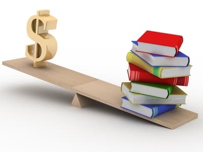 3D illustration of a wooden seesaw balancing a stack of colorful books on one side and a gold dollar sign on the other, symbolizing the value of education versus financial cost.