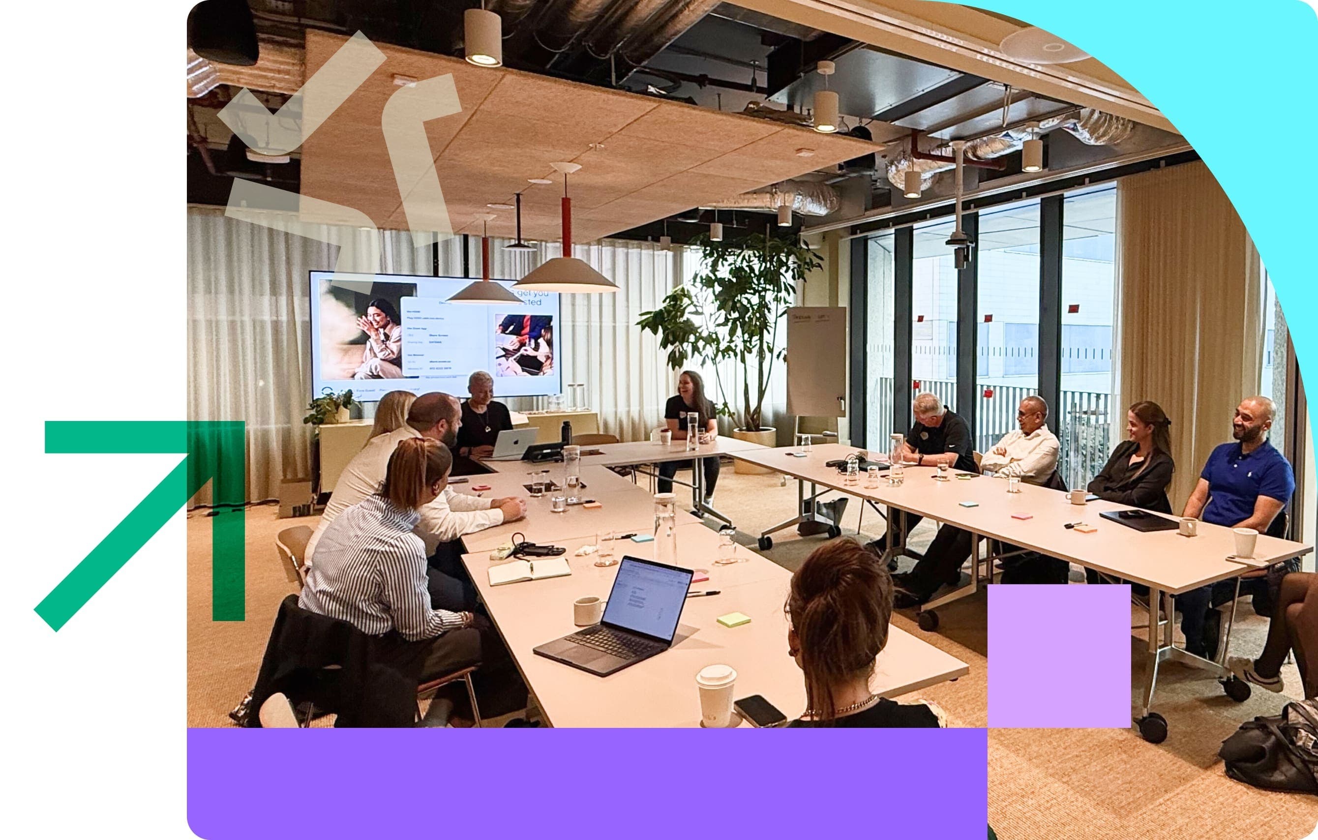 Group meeting at a large desk in an office setting