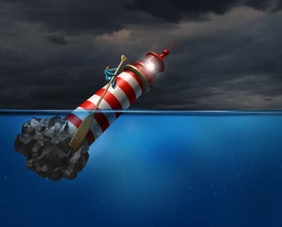 Lighthouse sinking in ocean with person stranded on top